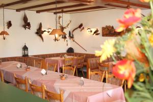 a dining room with tables and chairs and birds on the wall at Haus Sonnenschein in Üdersdorf