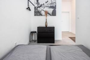 a bedroom with a bed and a vase on a dresser at Altenbeken- Ferienwohnung 1 in Altenbeken