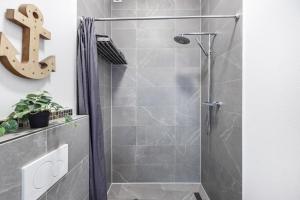 a shower stall in a bathroom with a dollar sign on the wall at Altenbeken- Ferienwohnung 1 in Altenbeken +13 photos