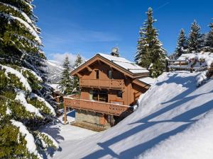 a log cabin in the snow with snow covered trees at Chalet chaleureux avec cheminée, jacuzzi et parking à Méribel - FR-1-688-18 in Méribel