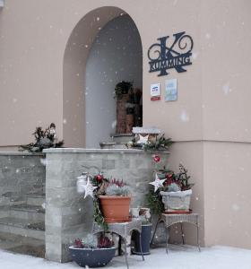 a building with christmas decorations on it in the snow at Kumming incl Nationalparkcard in Rauris