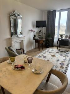 a living room with a table and chairs and a living room with a fireplace at Cocoon Retreat in Chantilly