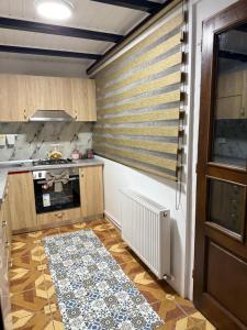 a kitchen with a stove top oven next to a window at La Canton Cheia in Cheia