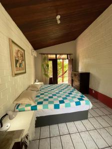 a bedroom with a large bed in a room at Vila Caribé in Lençóis