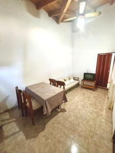 a room with a table and a couch and a tv at Pepina Mina Clavero in Mina Clavero +3 photos