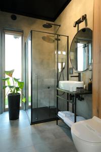 a bathroom with a glass shower and a sink at Górskie Kąty Resort Michałkowa in Michałkowa +132 photos