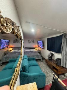 a living room with two beds and a couch at Tower District Hostel in Fresno