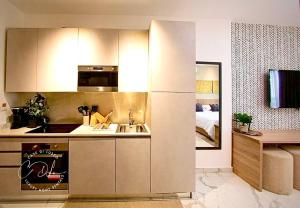 una cocina con fregadero y refrigerador en Stylish Spacious Studio with Pool & Fitness Centre, en Accra