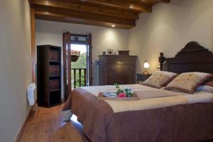 a bedroom with a large bed with a tray on it at La Casona de Riomera in Santibáñez de la Fuente