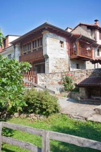a house with a fence in front of it at La Casona de Riomera in Santibáñez de la Fuente +10 photos