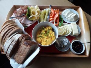 a tray of food with bread and a bowl of food at Willa Anna in Nałęczów