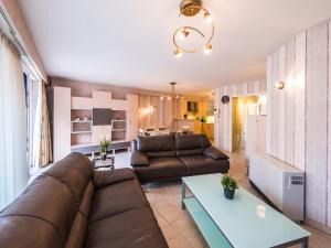 a living room with a couch and a table at Franklin - 0101 in Middelkerke