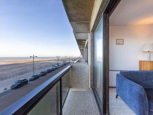 a view of a highway from a room with a blue couch at Dunekant - 0203 + park.6 in Miami Wijk