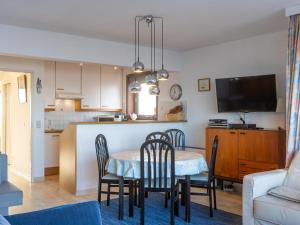 a kitchen and dining room with a table and chairs at Dunekant - 0203 + park.6 in Miami Wijk +3 photos