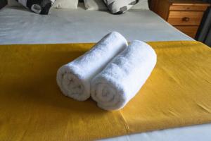 two rolled towels sitting on top of a bed at Seagull Apartment -2 Bedroom Apartment 408 by First Private Stays in Margate +26 photos
