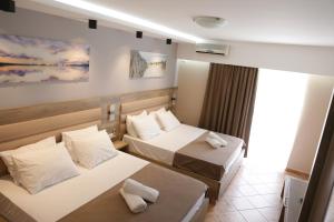 a hotel room with two beds and a window at Hotel Resort Comfort in Ulcinj +112 photos