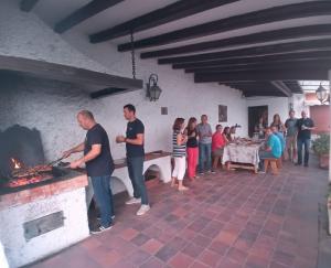 a group of people standing around a fireplace at Casa El Obrador in Arguedas