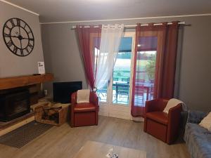 a living room with a couch and chairs and a window at Gîte spacieux avec salle de jeux, tennis et cheminée, idéal pour familles et amis jusqu'à 15 pers. - FR-1-410-223 in Saint-Jean-de-la-Motte