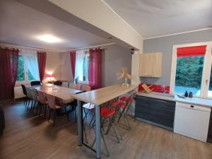 a kitchen and dining room with a table and chairs at Gîte spacieux avec salle de jeux, tennis et cheminée, idéal pour familles et amis jusqu'à 15 pers. - FR-1-410-223 in Saint-Jean-de-la-Motte