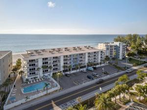 an aerial view of a building with a parking lot and the ocean at Holiday Villas II Unit 301 in Clearwater Beach