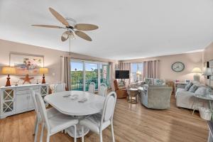 a living room with a white table and chairs at Holiday Villas II Unit 301 in Clearwater Beach