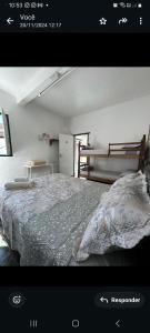 a picture of a bedroom with a bed at Quartos Sierra Tiradentes in Tiradentes