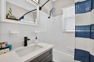 a white bathroom with a sink and a shower at Park Shore Suites Unit 6 in St. Pete Beach +45 photos