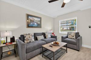 a living room with a couch and a table at Sunset Beach Suites Unit 4 in St. Pete Beach