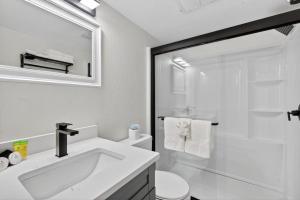 a white bathroom with a sink and a shower at Sunset Beach Suites Unit 4 in St. Pete Beach +43 photos