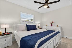 a bedroom with a bed and a ceiling fan at Sunset Beach Suites Unit 4 in St. Pete Beach