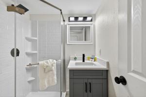 a white bathroom with a sink and a shower at Sunset Beach Suites Unit 2 in St. Pete Beach +39 photos
