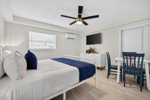 a bedroom with a bed with a ceiling fan at Sunset Beach Suites Unit 2 in St. Pete Beach