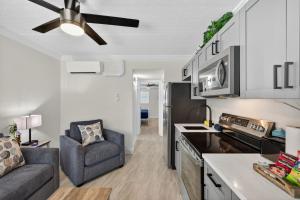 a kitchen with a couch and a chair in a room at Sunset Beach Suites Unit 2 in St. Pete Beach