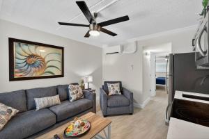 a living room with a couch and a ceiling fan at Sunset Beach Suites Unit 2 in St. Pete Beach