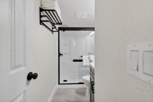 a white bathroom with a shower and a toilet at Sunset Beach Suites Unit 3 in St. Pete Beach +39 photos