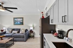 a kitchen and a living room with a couch at Sunset Beach Suites Unit 3 in St. Pete Beach