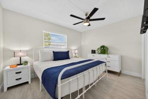 a bedroom with a bed and a ceiling fan at Sunset Beach Suites Unit 1 in St. Pete Beach