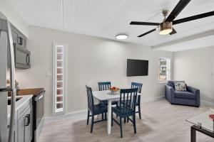 a kitchen and dining room with a table and chairs at Sunset Beach Suites Unit 1 in St. Pete Beach