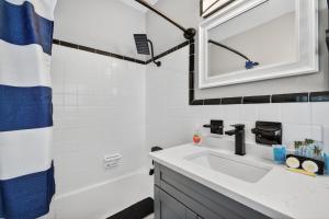 a bathroom with a sink and a mirror and a tub at Park Shores Suites Unit 9 in St Pete Beach +35 photos