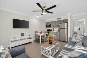 a living room with a couch and a table and a kitchen at Sunset Beach Suites Unit 9 in St Pete Beach