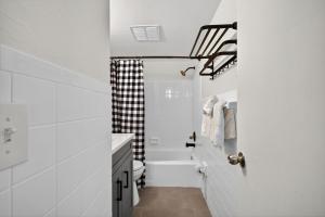a white bathroom with a shower and a toilet at Sunset Beach Suites Unit 9 in St Pete Beach +37 photos