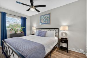 a bedroom with a bed and a ceiling fan at Sunset Beach Suites Unit 7 in St. Pete Beach