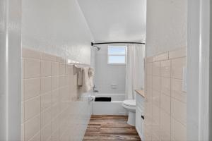 a white bathroom with a toilet and a window at Sunset Beach Suites Unit 6 in St. Pete Beach +37 photos