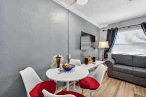 a living room with a table and chairs and a couch at Sunset Beach Suites Unit 6 in St. Pete Beach