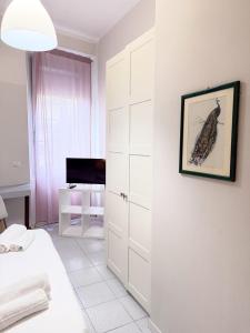 a white bedroom with a bed and a closet at EASYROOMS ONE in Parma +67 photos