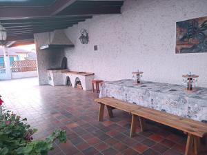 a patio with two tables and a table and benches at Casa El Obrador in Arguedas +84 photos