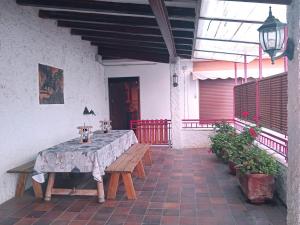 a table on a patio with a table cloth on it at Casa El Obrador in Arguedas