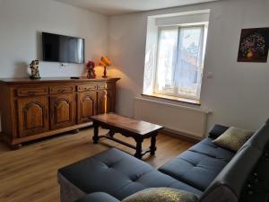 a living room with a couch and a coffee table at Gîte chaleureux sur une ferme en activité près de Nancy, idéal balades et proche commerces - FR-1-584-181 in Franconville