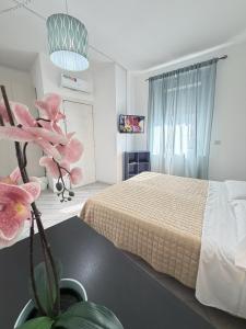 a bedroom with a bed and a potted plant at EASYROOMS ONE in Parma