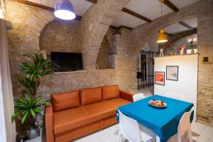 a living room with a couch and a table at Dimora del tufo in Narni